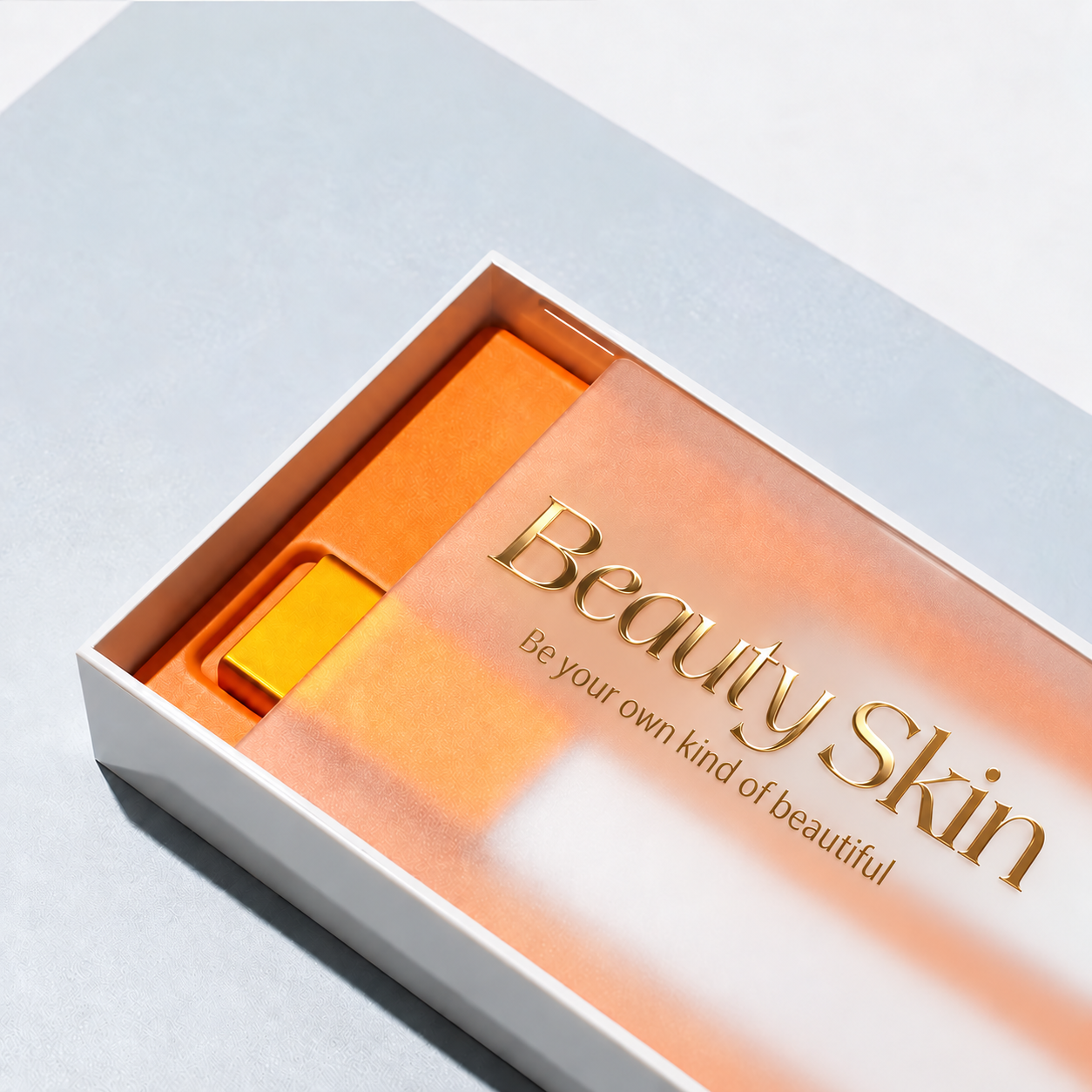 White cosmetic rigid box with a partially open transparent cover, gold Beauty Skin lettering and an orange fitted insert.