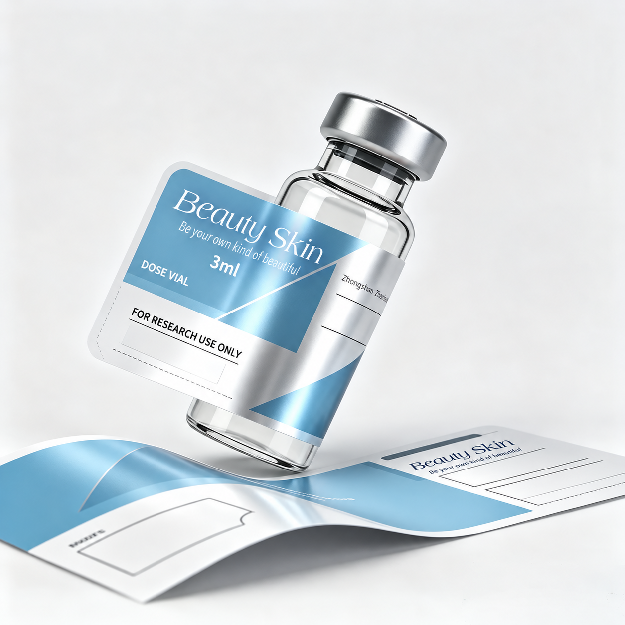 Glass vial with a partially applied blue and silver Beauty Skin label, alongside a matching printed label sample.