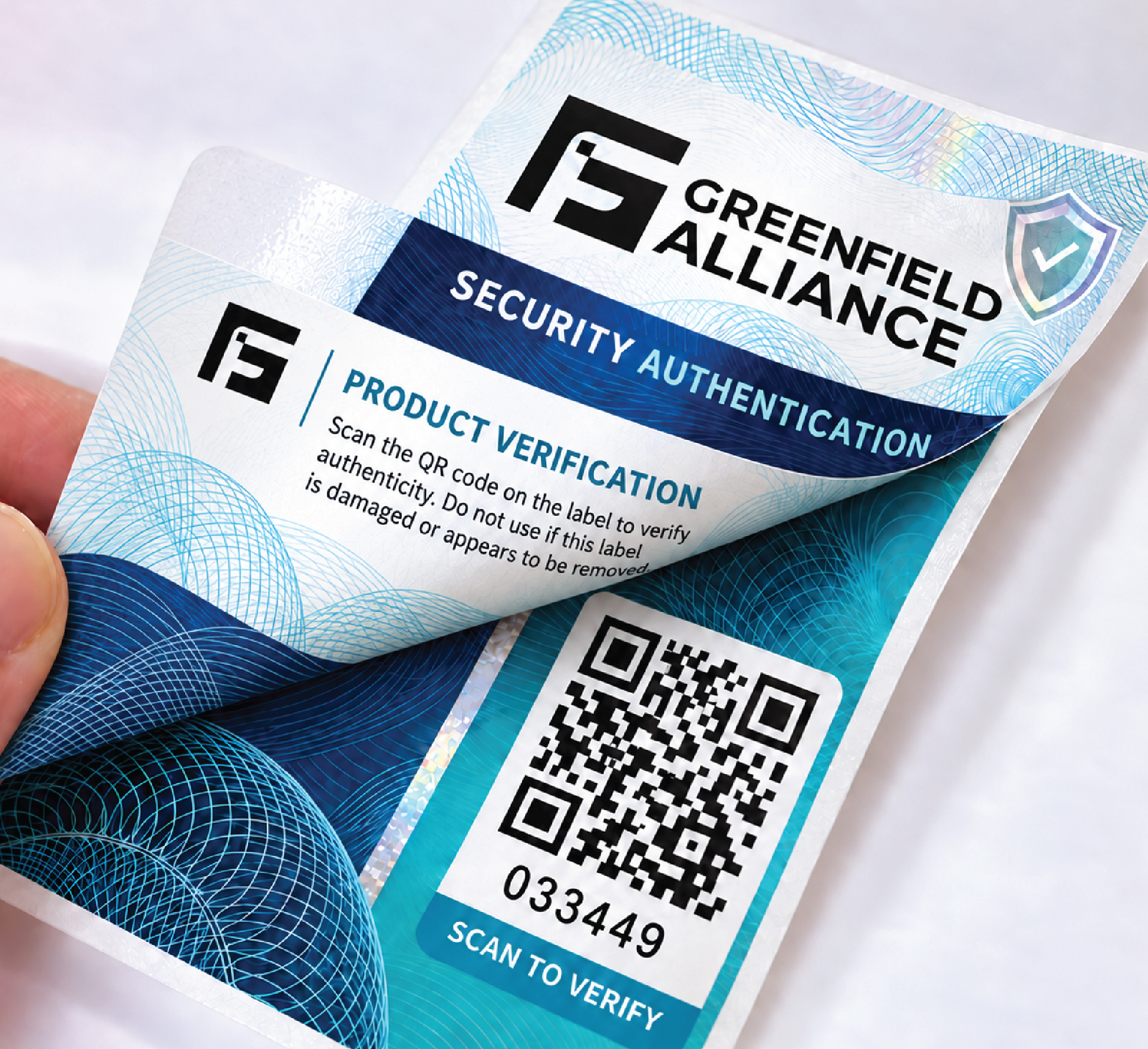 GFA multilayer security label with the top layer peeled back to reveal a QR code and serial number.